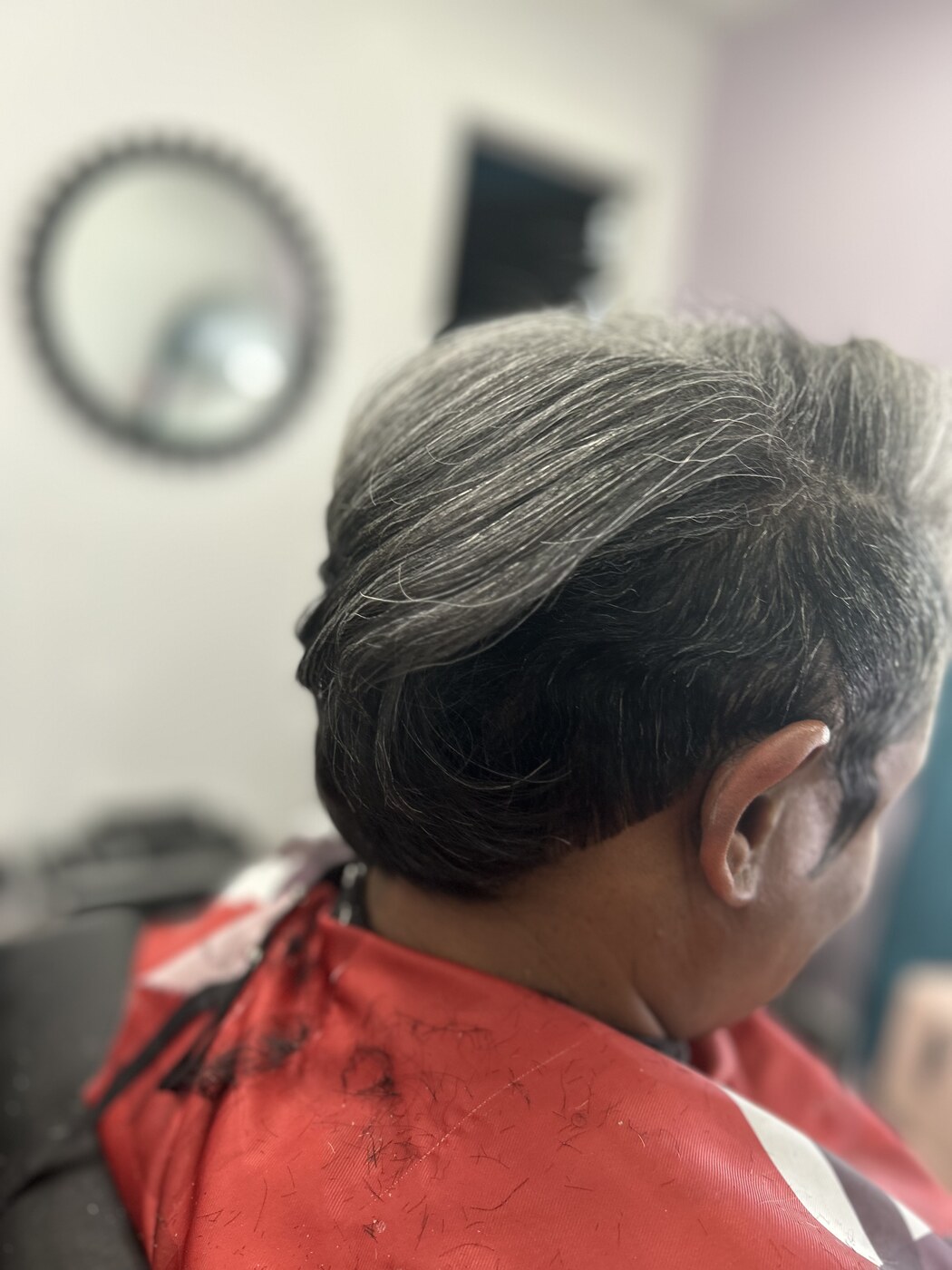 Short sculpted style pressed smooth with natural gray