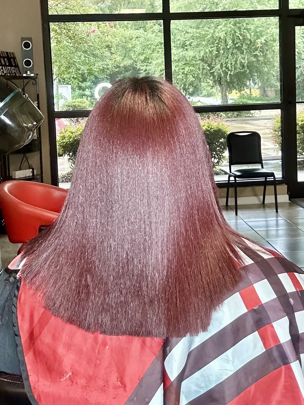 Long auburn color pressed straight with blunt, healthy ends